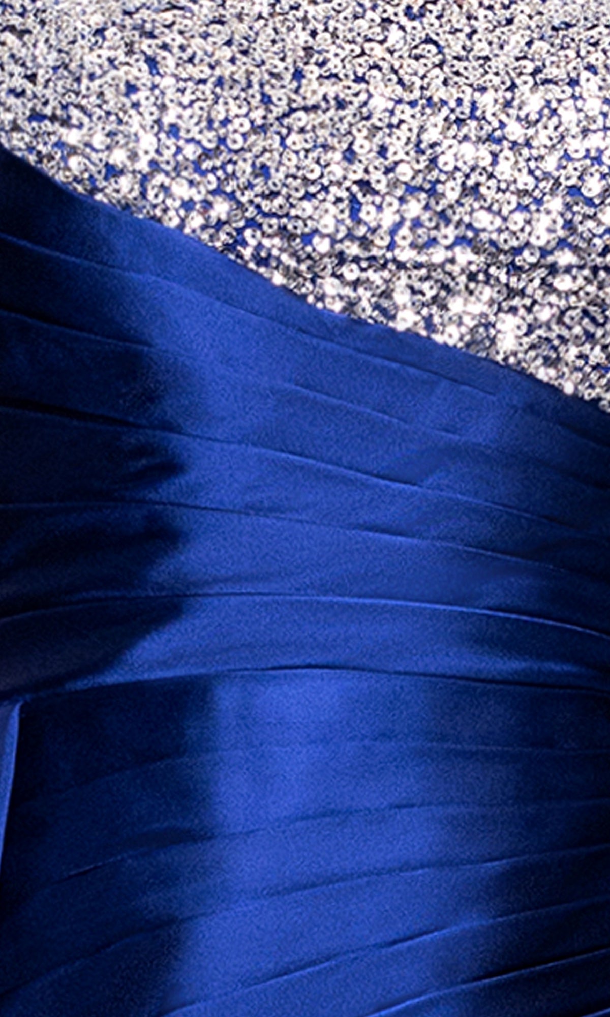 Close-up of the Blondie Nites 5423BN dress, a long blue formal gown with sequin embellishments, featuring a silver upper section and a shiny pleated blue lower half—ideal for any formal occasion.